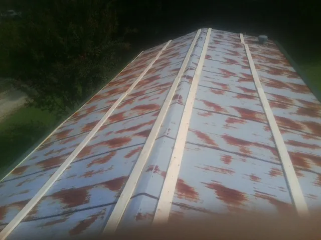 Rusted metal roof panels with new wood purlins before replacement — Storm Damage Roof Repair in Sylacauga by Roofing Brothers