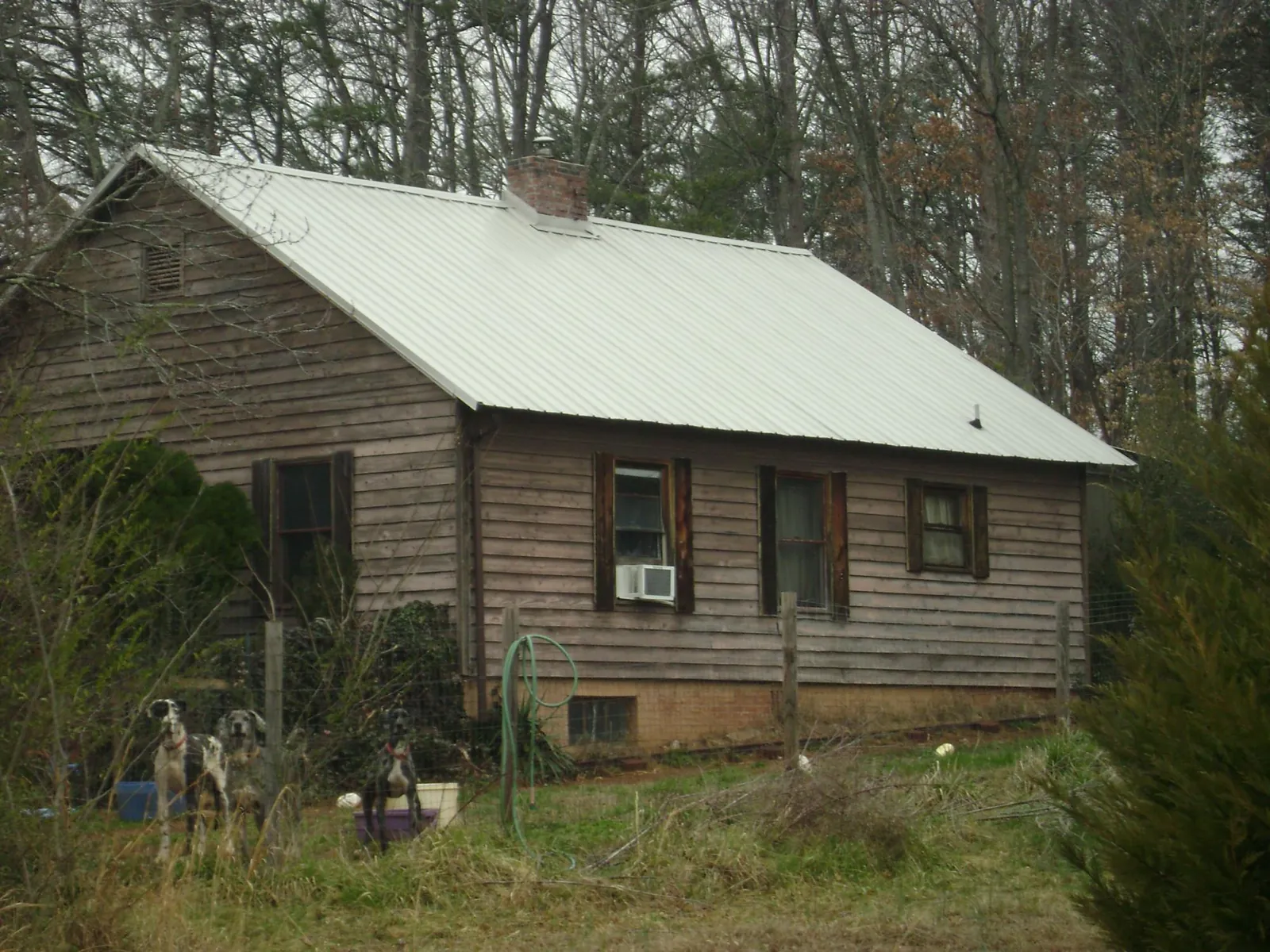 White metal roof on an old wood sided farmhouse, from a Metal Roof Installation job in Sylacauga